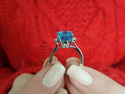 Diamond and oval blue topaz ring in 14 carat white gold
