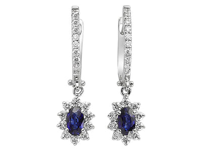 Diamond and oval cut sapphire earrings in 14 carat white gold