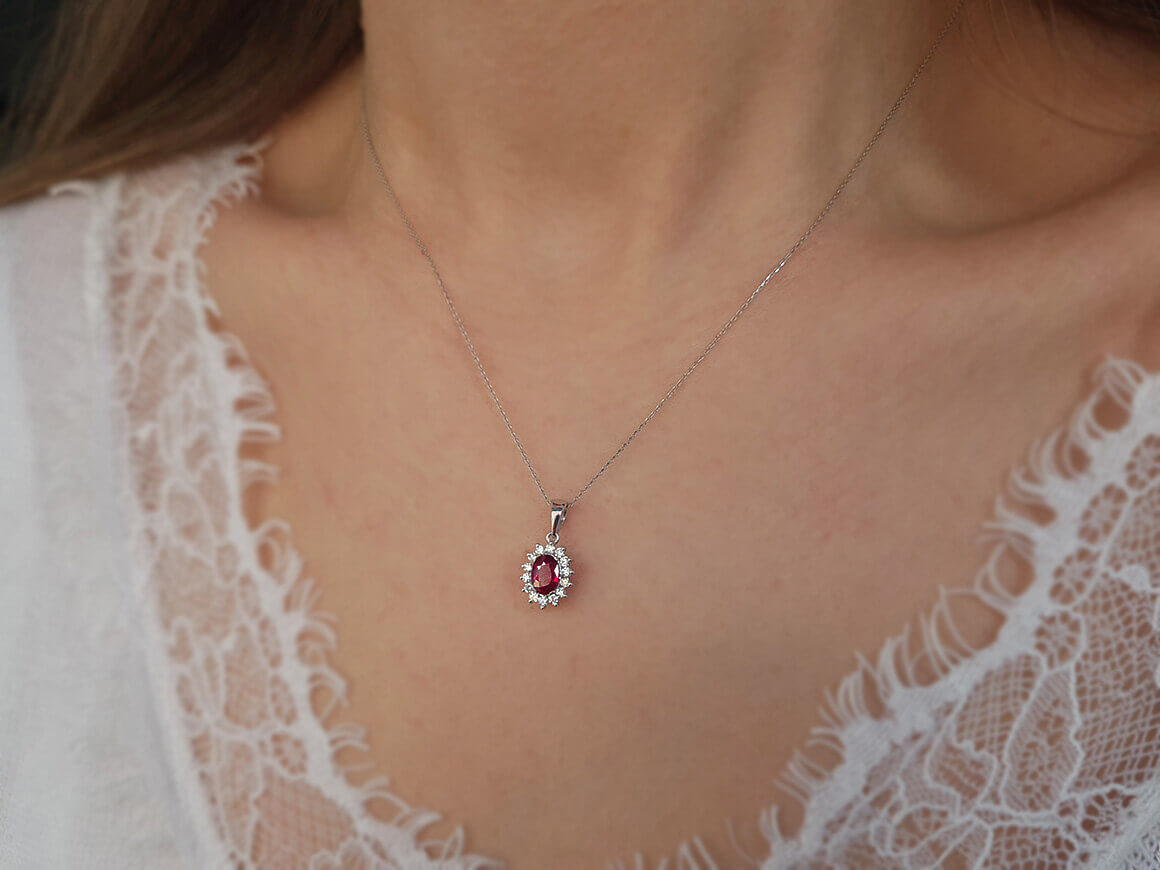 Diamond and oval ruby necklace in 14 K white gold