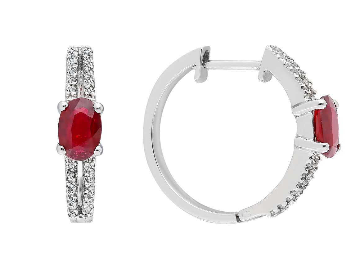 Diamond and oval ruby earrings in 14 carat white gold