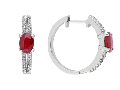 Diamond and oval ruby earrings in 14 carat white gold