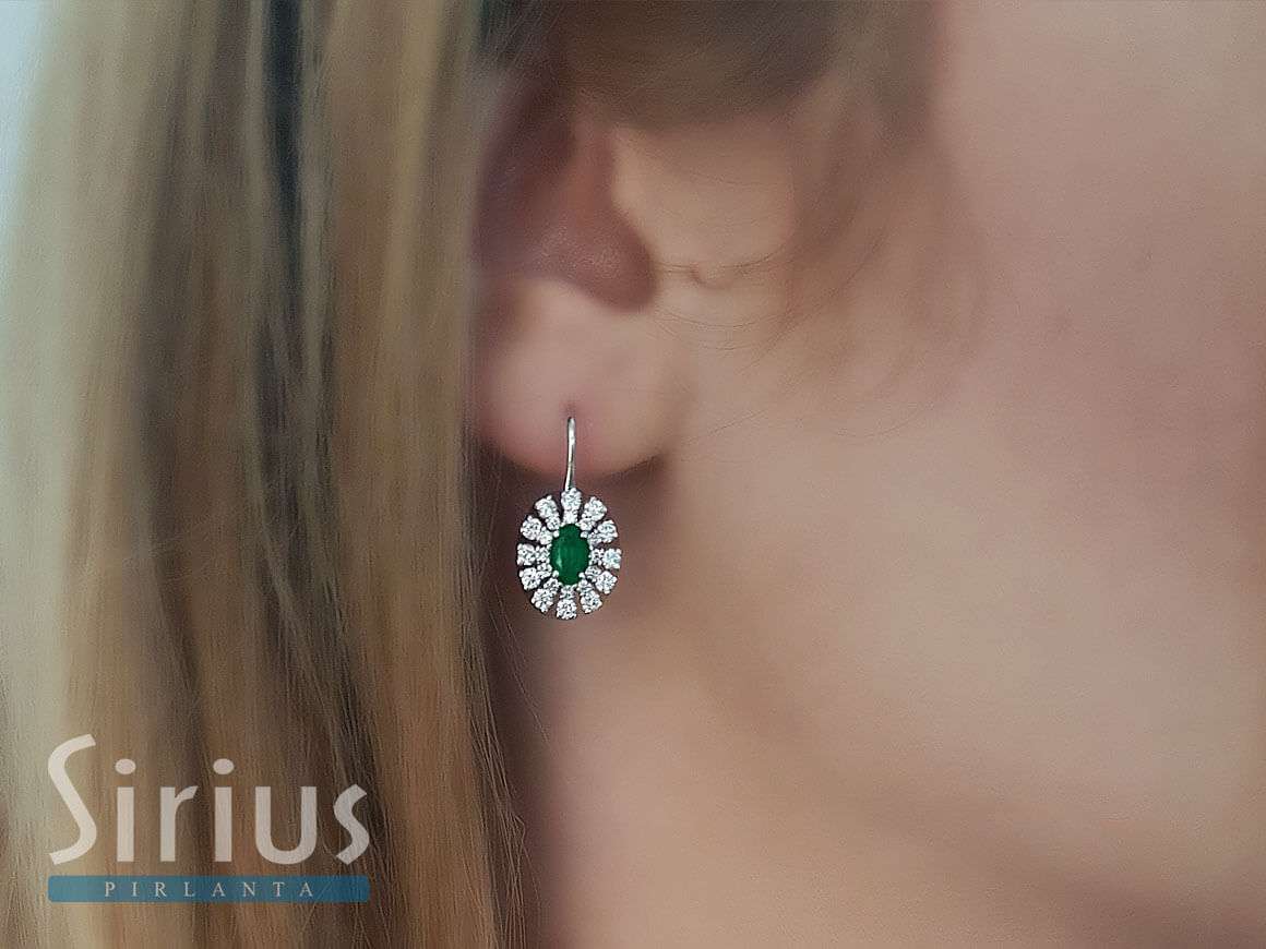 Diamond and oval emerald earrings in 14 carat white gold