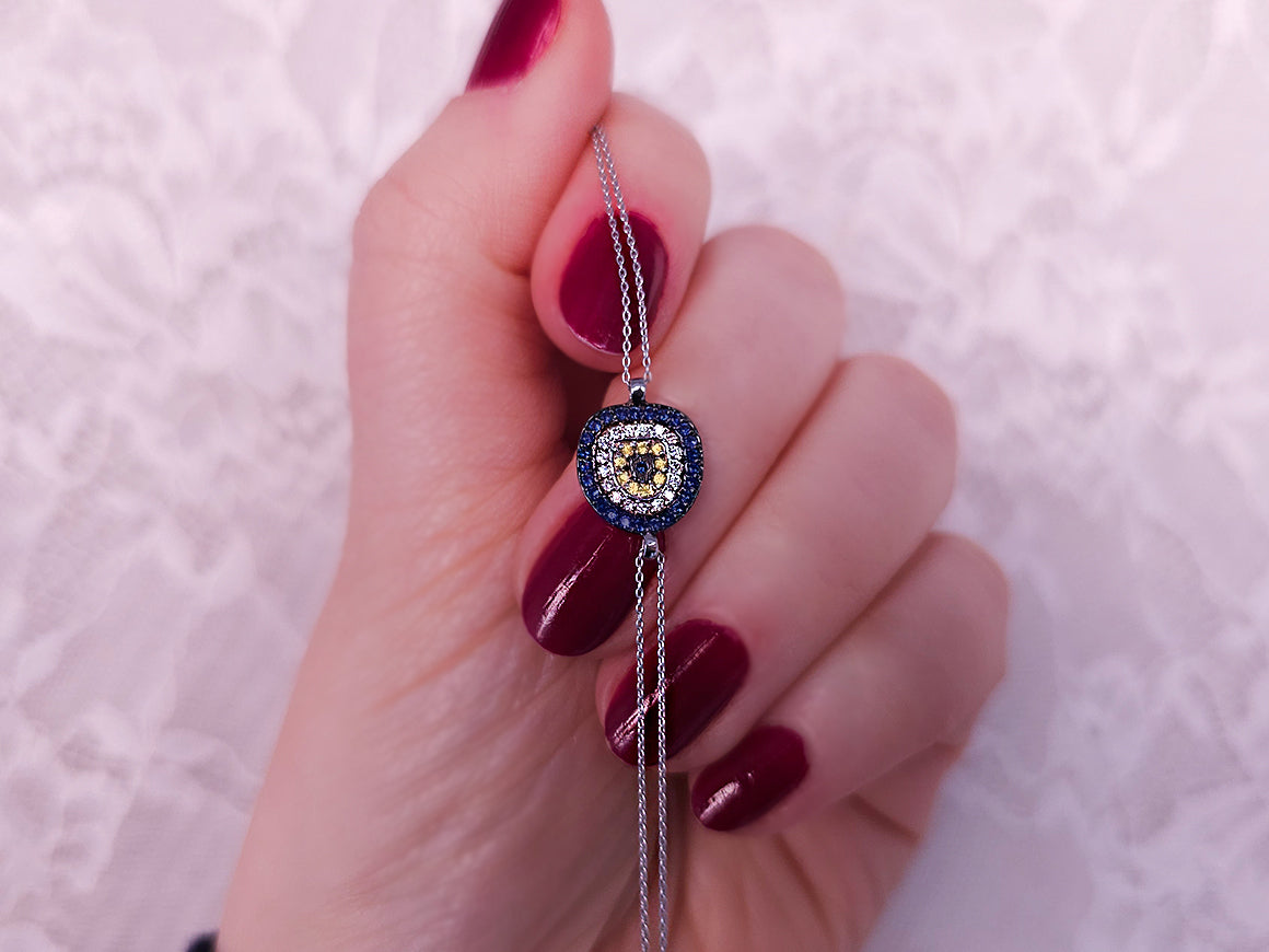 Diamond and sapphire eye motif bracelet in 14K white gold