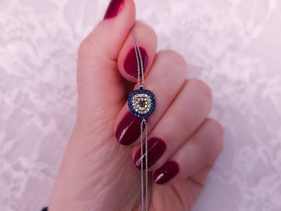 Diamond and sapphire eye motif bracelet in 14K white gold