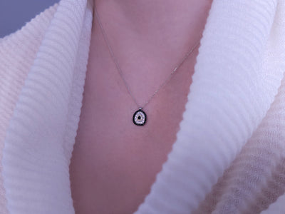 Diamond and sapphire "Blue Eye" motif necklace in 14-carat white gold