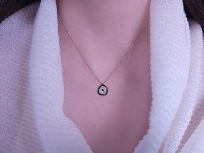 Diamond and sapphire "Blue Eye" motif necklace in 14-carat white gold