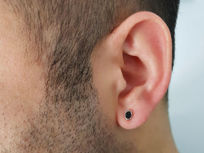 Oval black diamond men's stud earrings in 14 K white gold